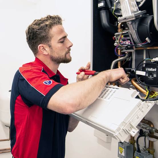 Gas engineer servicing a Vaillant boiler